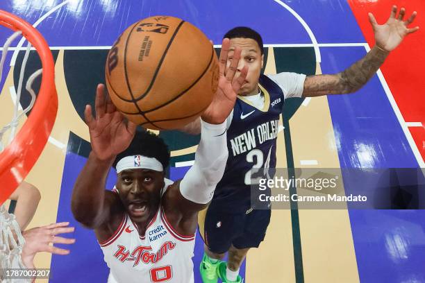 Aaron Holiday of the Houston Rockets drives to the net ahead of Jordan Hawkins of the New Orleans Pelicans during the second half at Toyota Center on...