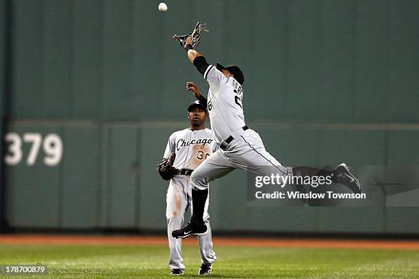 Avisail Garcia of the Chicago White Sox goes for a hit by Stephen Drew of the Boston Red Sox ,, which fell for a single as Alejandro De Aza of the...