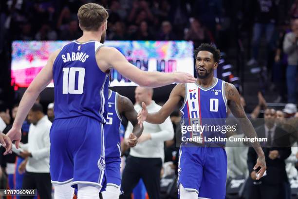 Malik Monk of the Sacramento Kings celebrates with Domantas Sabonis after making a basket in the fourth quarter against the Oklahoma City Thunder...