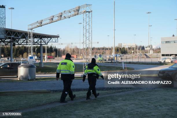 Custom officials walk near the Nuijamaa border crossing station between Finland and Russia, in Lappeenranta, southeastern Finland on November 17...