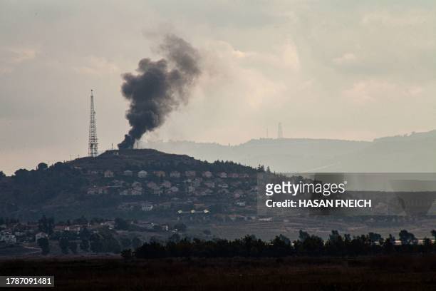 Smoke billows after an attack by the Shiite Muslim group Hezbollah on an Israeli military post in Metulla, facing the southern Lebanese border...