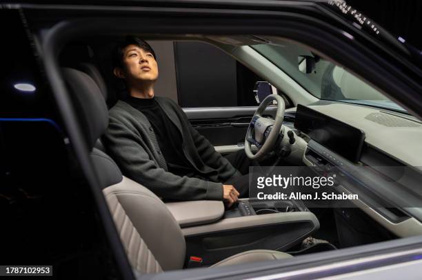Los Angeles, CA Sung Kwon Go, of Torrance, a Honda car designer, checks out the interior of the Kia EV9 at the LA Auto Show, one of the world's...