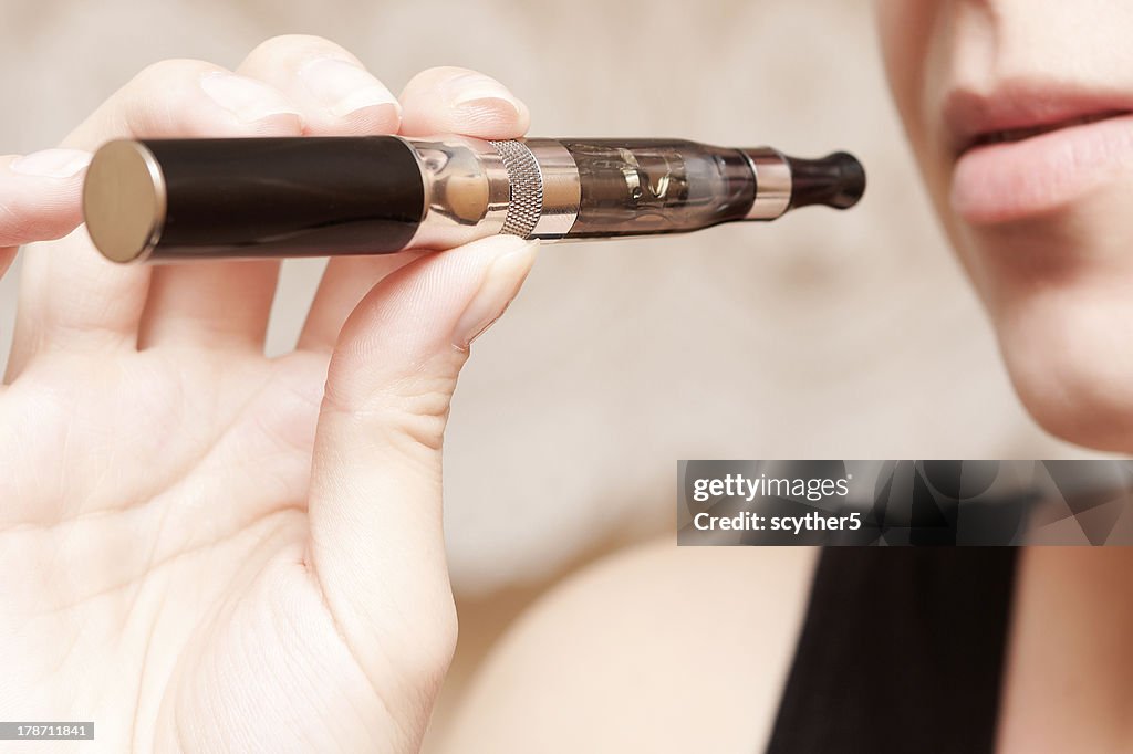 Woman smoking with electronic cigarette