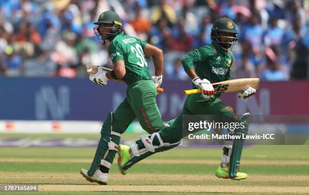 Towhid Hridoy and Mahmudullah of Bangladesh run between the wickets during the ICC Men's Cricket World Cup India 2023 between Australia and...