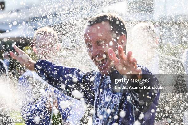 Jockey Damien Oliver is sprayed with champagne after his final Flemington carnival during Stakes Day at Flemington Racecourse on November 11, 2023 in...