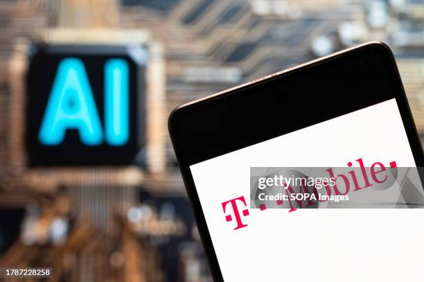 In this photo illustration, the German telecommunications company Deutsche Telekom AG, T-Mobile, logo seen displayed on a smartphone with an...