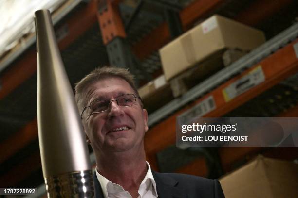 ArcelorMittal France's CEO Eric Niedziela holds an Olympic torch, ahead of Paris 2024 Olympic games, at the Degrenne manufacturing plant, in Vire,...