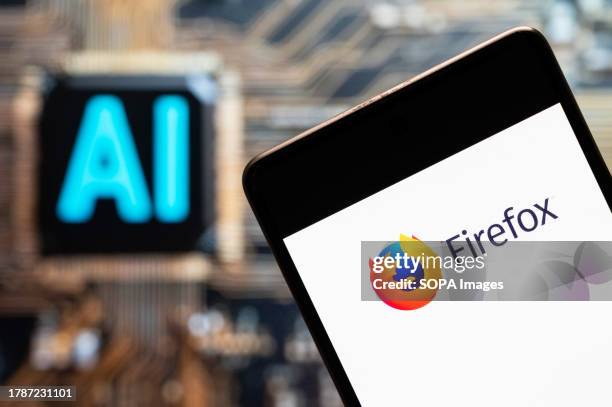 In this photo illustration, the open-source web browser developed by Mozilla Foundation, Firefox logo seen displayed on a smartphone with an...