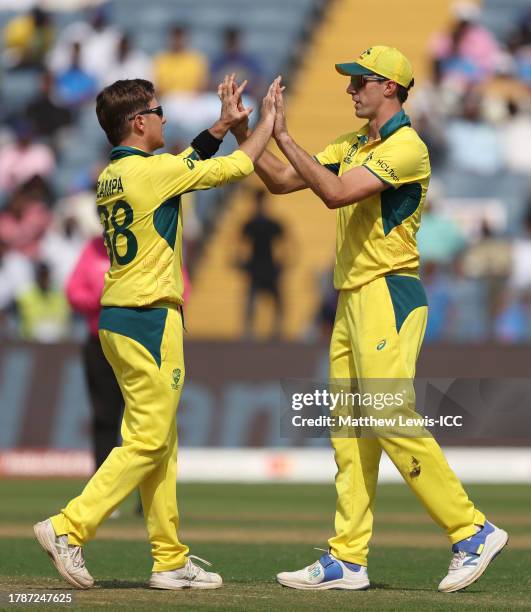 Adam Zampa of Australia celebrates the wicket of Mushfiqur Rahim of Bangladesh with team mate Pat Cummins during the ICC Men's Cricket World Cup...