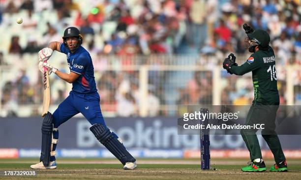 Dawid Malan of England plays a shot as Muhammad Rizwan of Pakistan keeps during the ICC Men's Cricket World Cup India 2023 between England and...