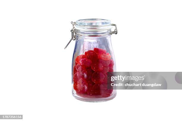 sweets and candy in glass jars on a white background - candy jar stock pictures, royalty-free photos & images