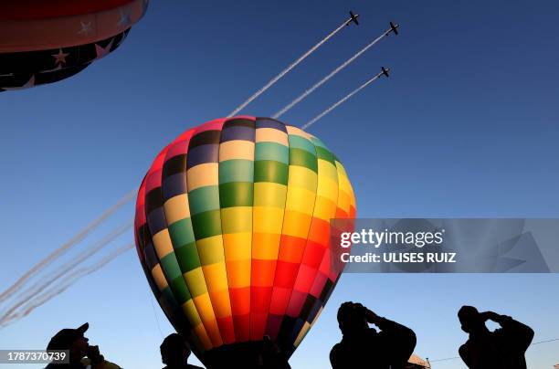 Mexican Air Force planes perform during the 21st International Hot Air Balloon Festival in Leon, Guanajuato state, Mexico on November 17, 2023.