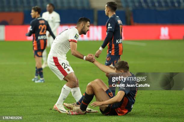 Gaetan Laborde of Nice helps Maxime Esteve of Montpellier to get up during the Ligue 1 Uber Eats match between Montpellier HSC and OGC Nice at Stade...