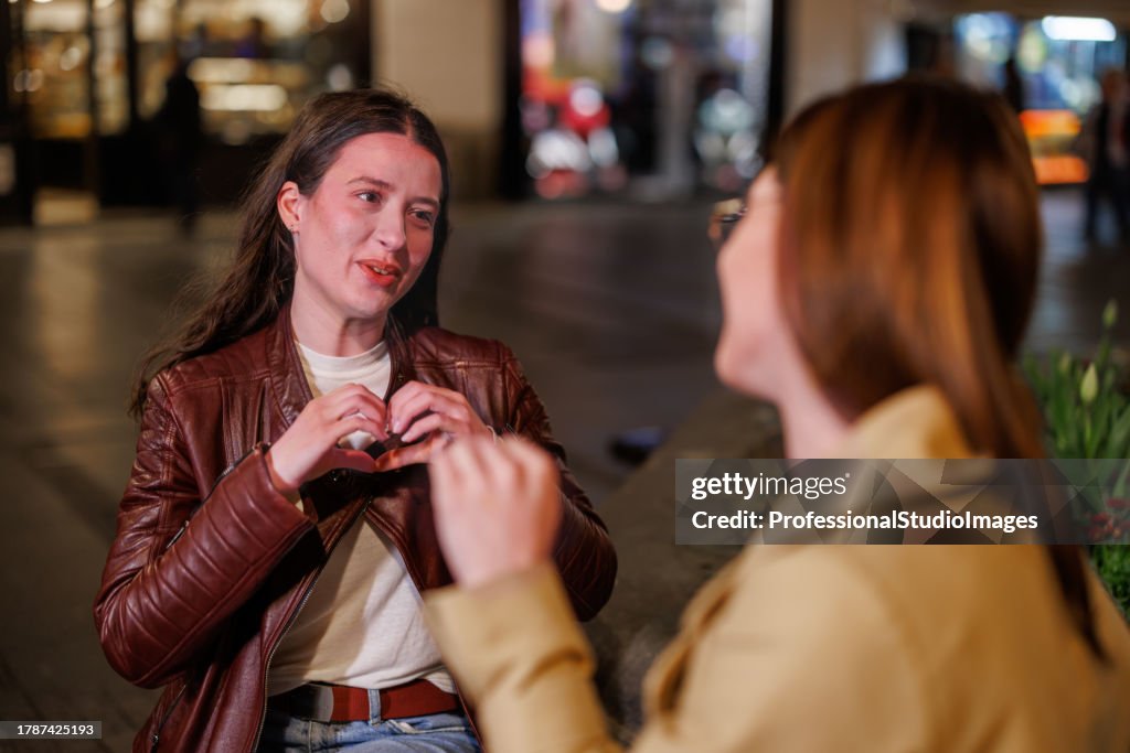 Two Friends Converse in Sign Language, Creating a Symphony of Communication