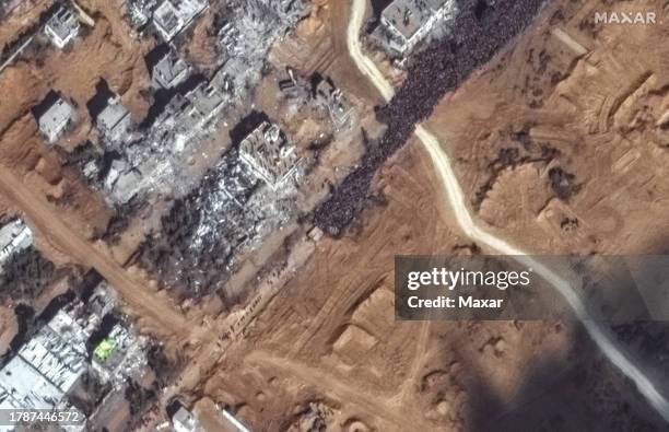 Maxar closeup satellite imagery shows a large crowd of people gathered along Salah al Deen Road in southern Gaza attempting to flee south along the...