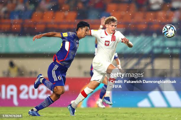 Kotaro Honda of Japan and Daniel Mikolajewski of Poland compete for the ball during the FIFA U-17 World Cup Group D match between Japan and Poland at...
