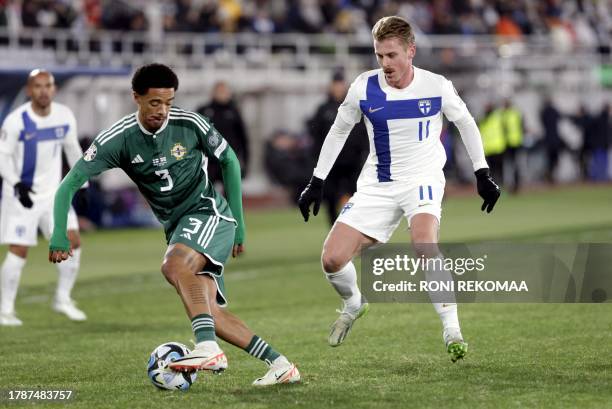 Finland's midfielder Rasmus Schuller and Northern Ireland's defender Jamal Lewis vie for the ball during the UEFA Euro 2024 Group H qualification...