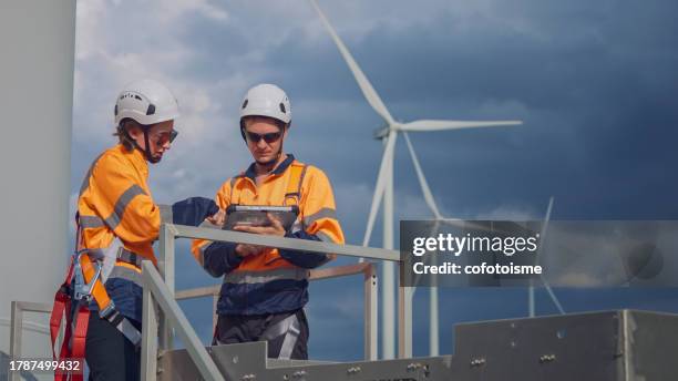 wind turbine engineer maintenance team working and discussing inspection at the wind turbine power station - wind power stock pictures, royalty-free photos & images