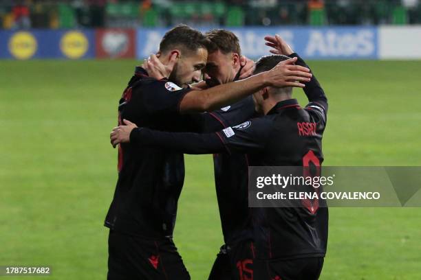 Albania's forward Sokol Cikalleshi celebrates with teammates after he scored his team's first goal during the UEFA Euro 2024 Group E qualifying...