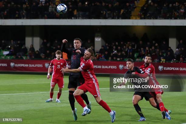 Albania's forward Taulant Seferi fights for the ball with Moldova's defender Oleg Reabciuk during the UEFA Euro 2024 Group E qualifying football...