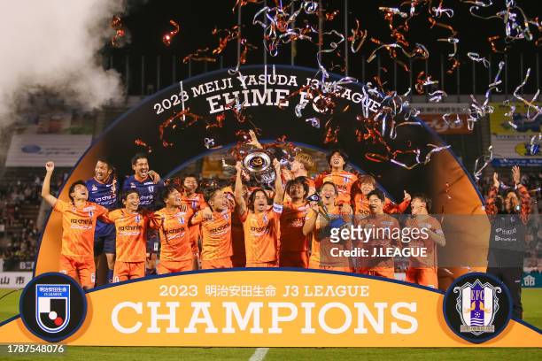 Riki MATSUDA of Ehime FC lifts the schale as they celebrates J3 champions with team mates after the J.LEAGUE Meiji Yasuda J3 35th Sec. Match between...