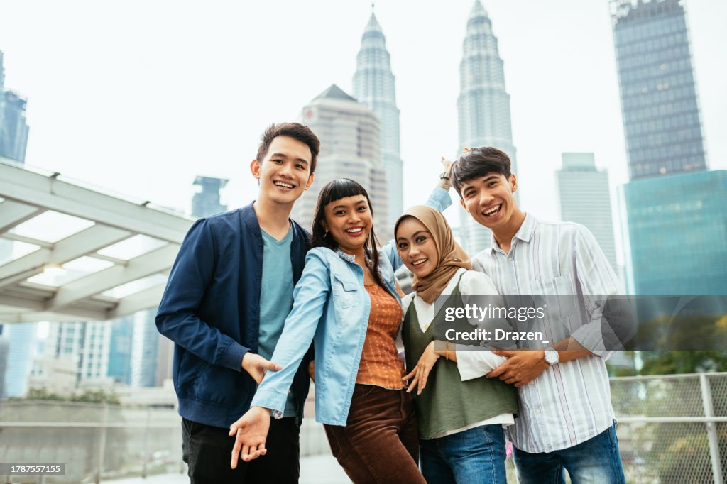 South East Asian youth in the city. Group of diverse young Asian people looking at camera while standing on Saloma bridge