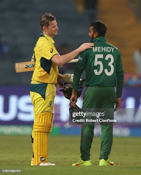 Mehidy Hasan of Bangladesh and Steve Smith of Australia interact following the ICC Men's Cricket World Cup India 2023 between Australia and...