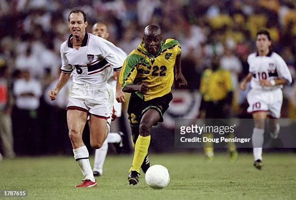 Thomas Dooley of the United States runs toward Paul Hall of Jamaica during a World Cup qualifier match at RFK Stadium in Washington, D. C. The game...