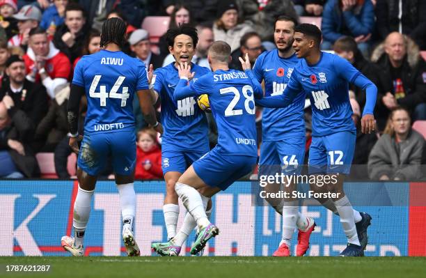 Birmingham player Koji Miyoshi celebrates with team mates after scoring the first Birmingham goal during the Sky Bet Championship match between...