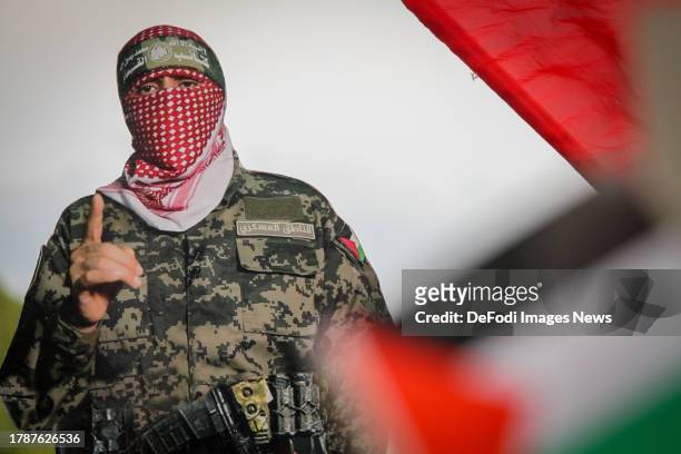 Tunisians holding banner of Abu Ubaida, the spokesman of the Izz el-Deen al-Qassam Brigades gather to stage a demonstration in streets and march...