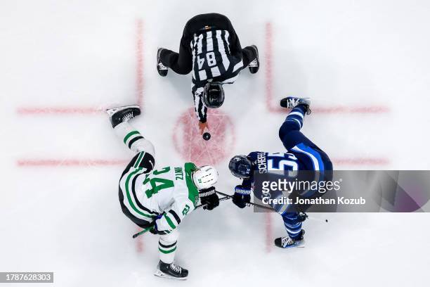 Roope Hintz of the Dallas Stars and Mark Scheifele of the Winnipeg Jets take a third period face-off at Canada Life Centre on November 11, 2023 in...