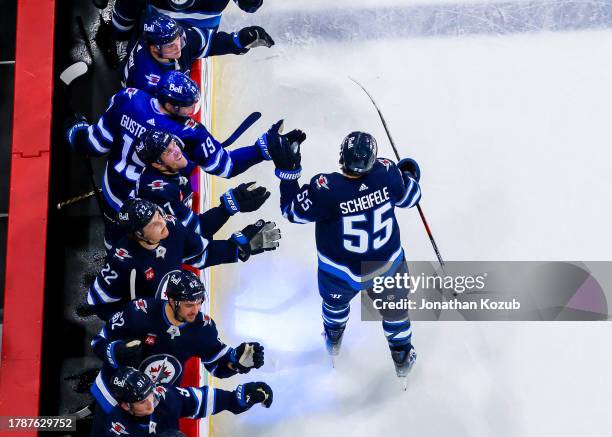 Mark Scheifele of the Winnipeg Jets skates by the bench to celebrate his team's third period goal against the Dallas Stars at Canada Life Centre on...