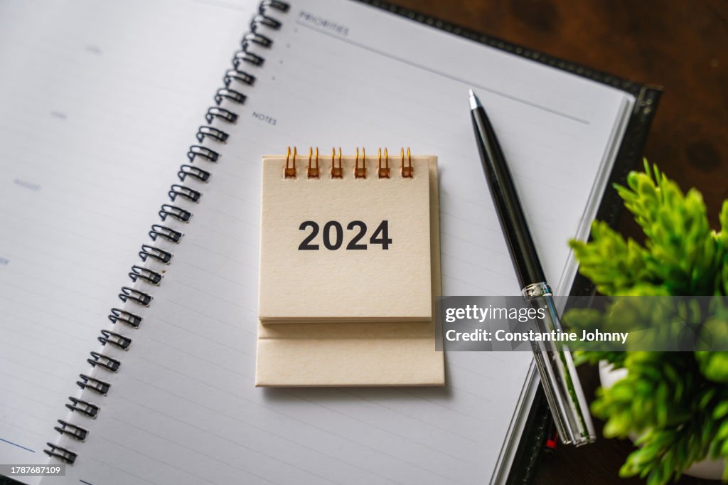 Planning for 2024. Desk with Calendar and Notebook.