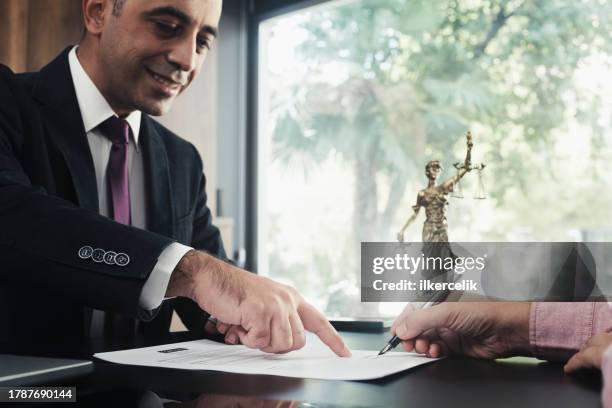 lawyer and the client signing legal agreement documents - aviso legal imagens e fotografias de stock
