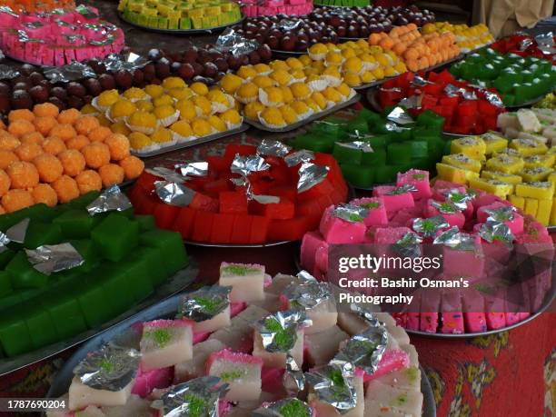 sweats displayed. street around shrine of  sufi saint jamil shah datar girnari - india pakistan stock pictures, royalty-free photos & images