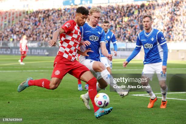 Karim Onisiwo of 1.FSV Mainz 05 and Christoph Klarer of SV Darmstadt 98 battle for the ball during the Bundesliga match between SV Darmstadt 98 and...