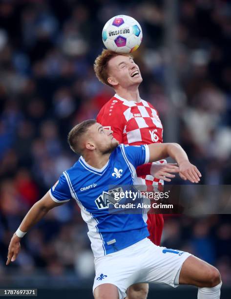 Sepp van den Berg of 1.FSV Mainz 05 wins a header over Fabian Nuernberger of SV Darmstadt 98 in the air during the Bundesliga match between SV...