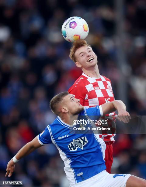 Sepp van den Berg of 1.FSV Mainz 05 wins a header over Fabian Nuernberger of SV Darmstadt 98 in the air during the Bundesliga match between SV...