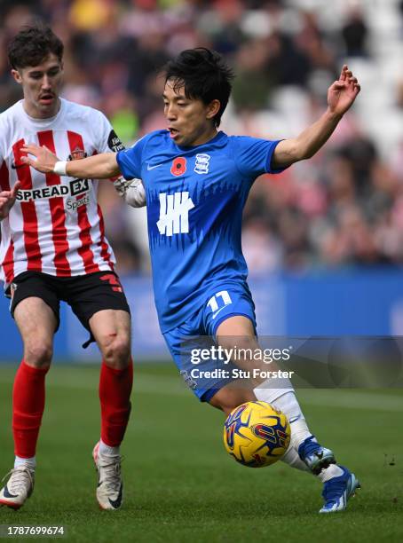 Birmingham player Koji Miyoshi holds off the challenge of Sunderland player Dennis Cirkin during the Sky Bet Championship match between Sunderland...