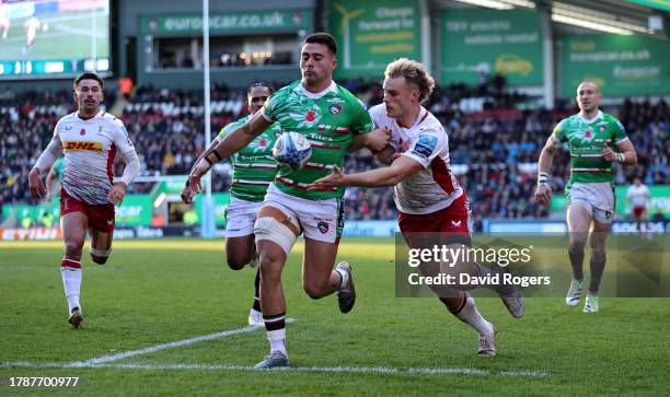 Dan Kelly of Leicester Tigers races after the loose ball with Louis Lynagh during the Gallagher Premiership Rugby match between Leicester Tigers and...