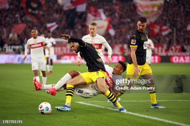 Jamie Leweling of VfB Stuttgart is challenged by Rami Bensebaini of Borussia Dortmund during the Bundesliga match between VfB Stuttgart and Borussia...