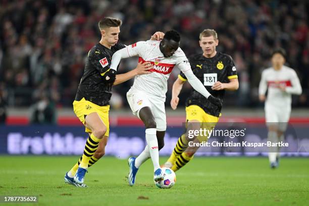 Silas Katompa Mvumpa of VfB Stuttgart is challenged by Nico Schlotterbeck of Borussia Dortmund during the Bundesliga match between VfB Stuttgart and...