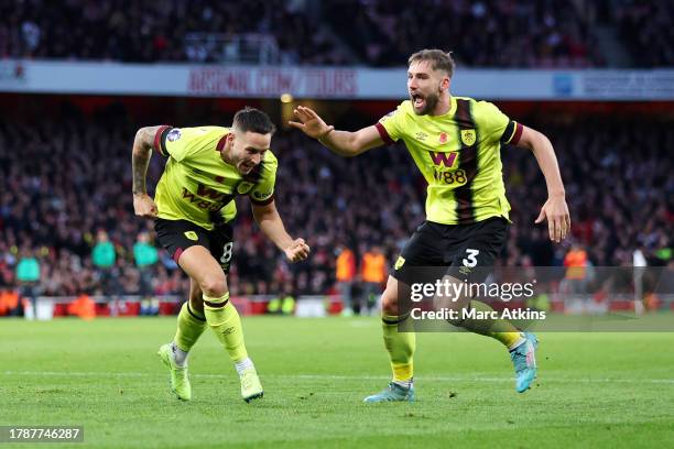 Josh Brownhill of Burnley celebrates with teammate Charlie Taylor after scoring the team's first goal during the Premier League match between Arsenal...