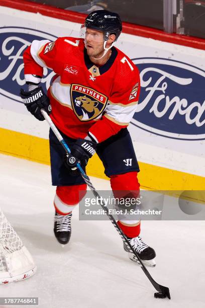 Dmitry Kulikov of the Florida Panthers skates with the puck against the Carolina Hurricanes at the Amerant Bank Arena on November 10, 2023 in...