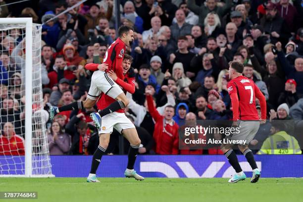Victor Lindeloef of Manchester United celebrates with teammate Sergio Reguilon after scoring the team's first goal during the Premier League match...
