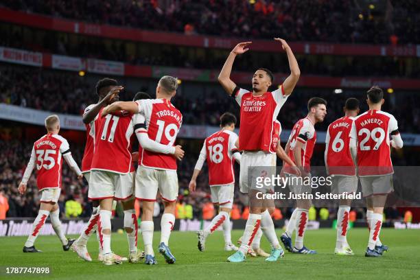William Saliba of Arsenal celebrates with teammates after scoring the team's second goal during the Premier League match between Arsenal FC and...
