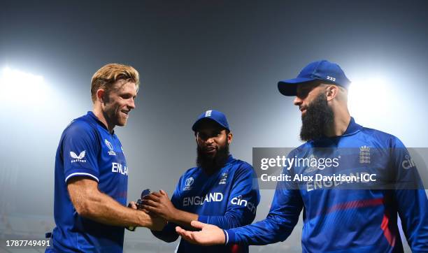 David Willey, Adil Rashid and Moeen Ali of England interact following the ICC Men's Cricket World Cup India 2023 between England and Pakistan at Eden...