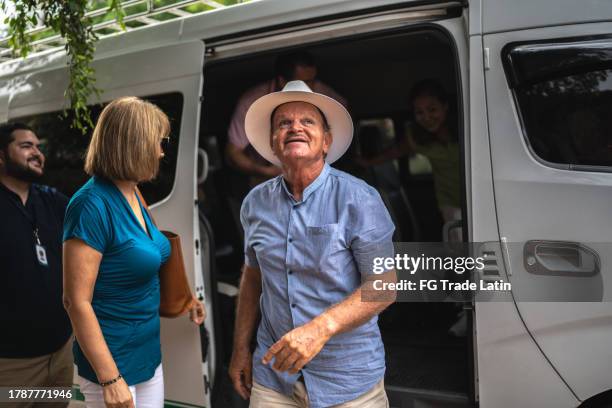 tourist seniors getting out of the van outdoors - bus tour guide stock pictures, royalty-free photos & images