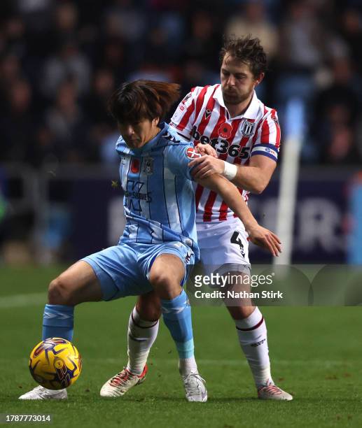 Tatsuhiro Sakamoto of Coventry and Ben Pearson of Stoke City compete for the ball during the Sky Bet Championship match between Coventry City and...