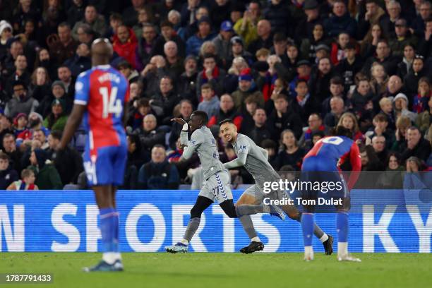 Idrissa Gueye of Everton celebrates with teammate Dwight McNeil after scoring the team's third goal during the Premier League match between Crystal...